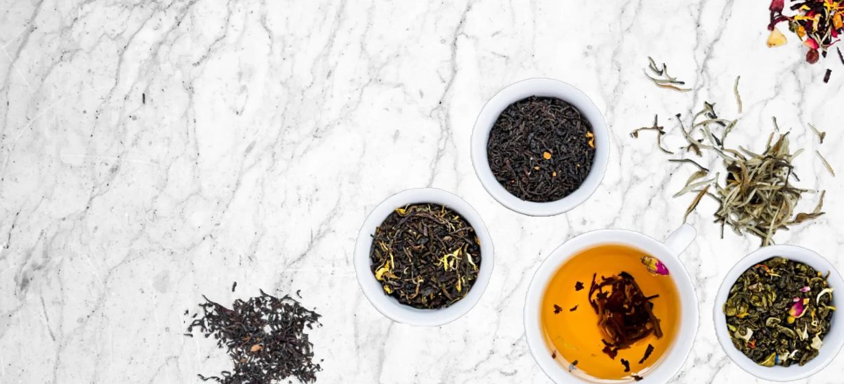 Tea and herbs on marble table top