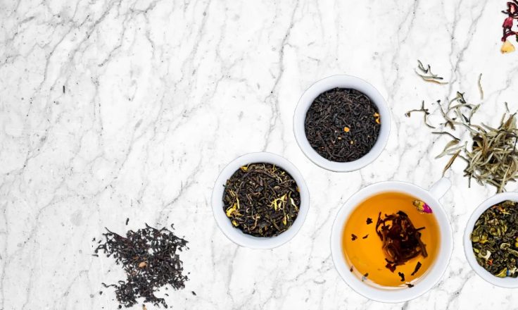 Tea and herbs on marble table top